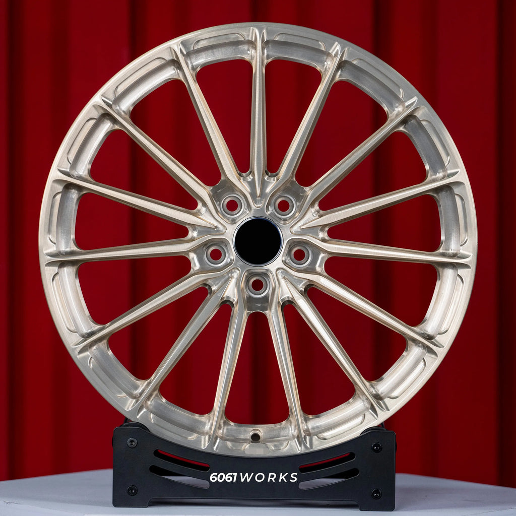 Audi RS E-TRON GT FW 21 inch custom forged wheels | P103SC style Brushed with Gold coating finish, straight front view on red backdrop showing intricate multi-spoke arrangement