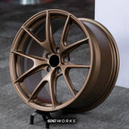 BMW M2 G87 19 inch custom forged wheels | Apex VS-5RS style Satin Bronze finish, dynamic side-angle view displaying deep concave profile and satin bronze coat