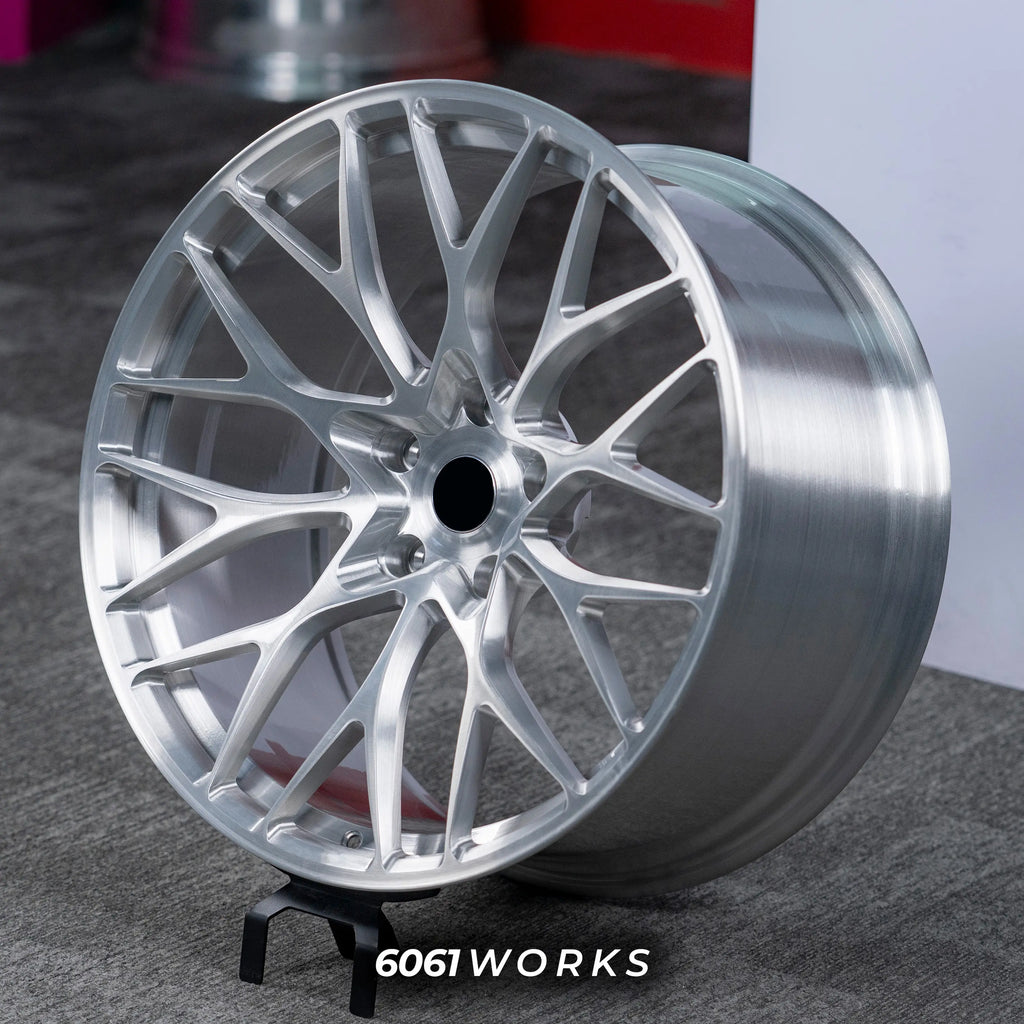 BMW M5 F90 21 inch custom forged wheels | 520M style Brushed Silver finish, dynamic side-angle view on gray background displaying hand-brushed metallic texture and rim lip