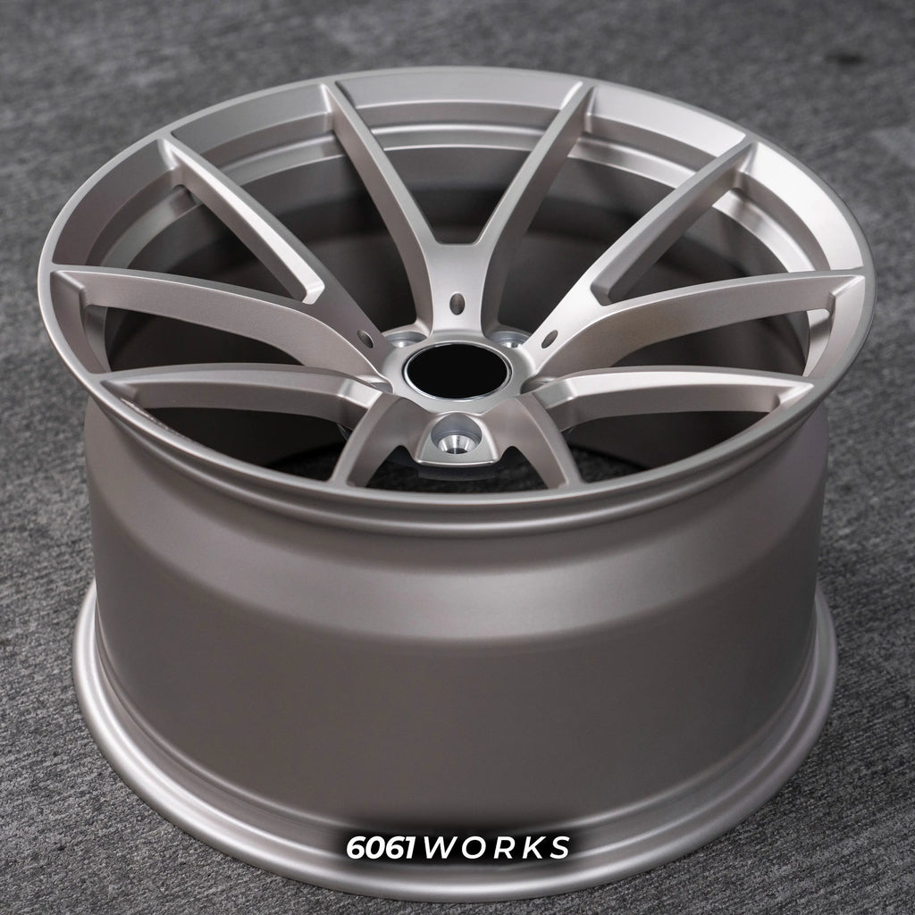 BMW M5 G90 22 inch custom forged wheels | OEM BMW 763M style Satin Gold finish, top-down angled profile view showing full wheel width and inner barrel