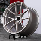 BMW M5 G90 22 inch custom forged wheels | OEM BMW 763M style Satin Gold finish, three-quarter view on display stand showing lightweight performance Y-spoke geometry