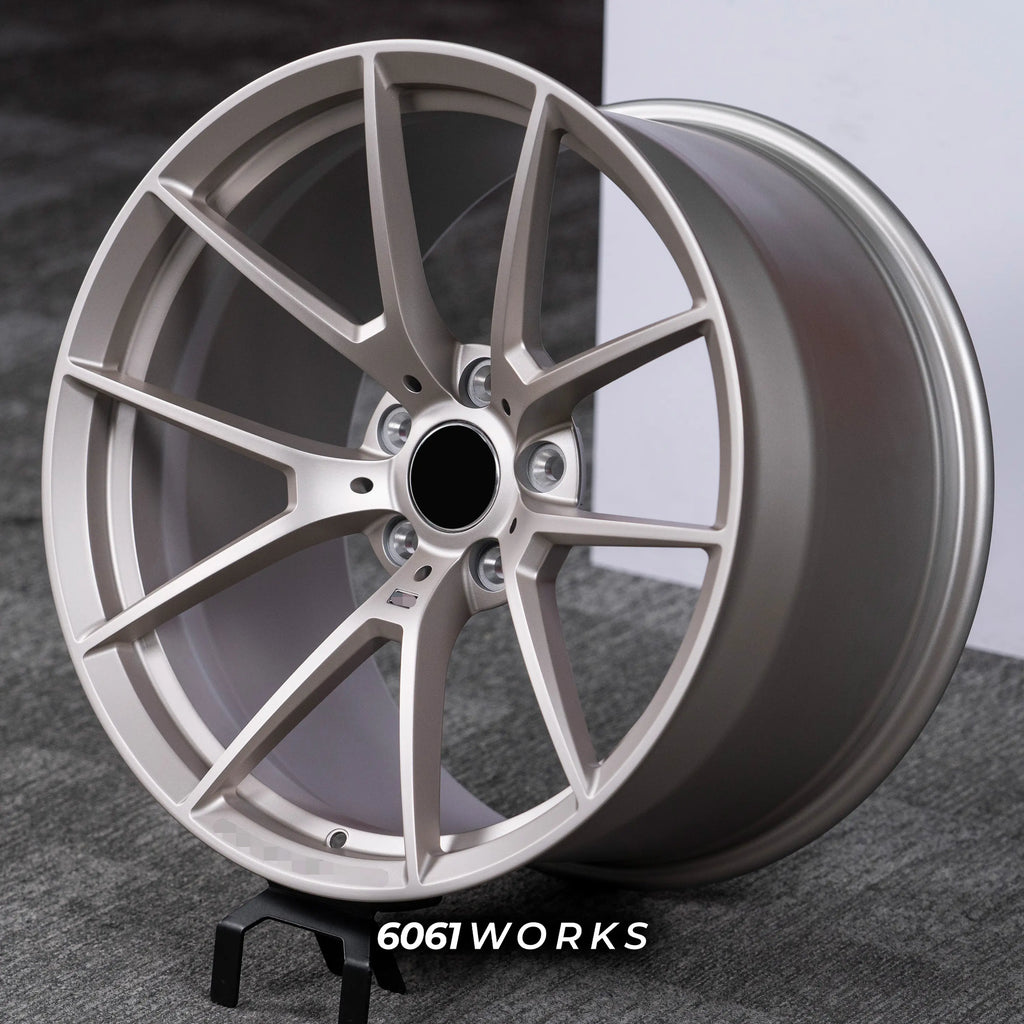 BMW M5 Touring G99 22 inch custom forged wheels | OEM BMW 763M style Satin Gold finish, dynamic side-angle view displaying concave profile and subtle satin sheen