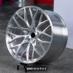 MW X6 G06 22 inch custom forged wheels | 520M style Brushed Silver finish, dynamic side-angle view on gray background displaying hand-brushed metallic texture and rim lip
