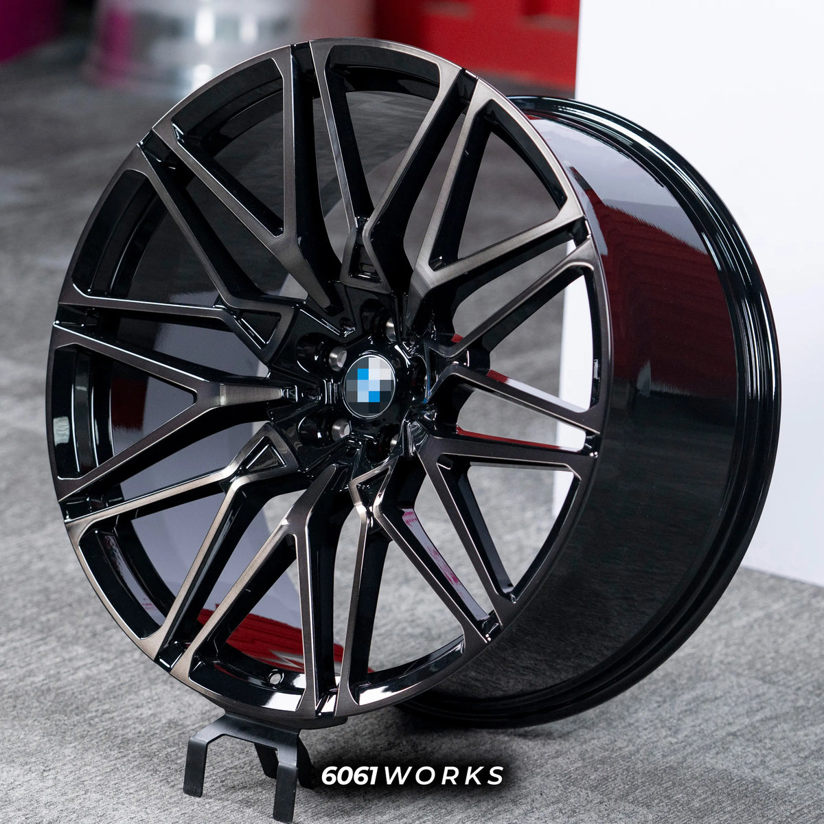 BMW X6 G06 22 inch custom forged wheels | OEM BMW 818M style Gloss Black with Machined Face Dark Coating, dynamic side-angle view on gray background displaying deep concave profile