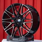 BMW X6 G06 22 inch custom forged wheels | OEM BMW 818M style Gloss Black with Machined Face Dark Coating, dynamic angled view on display stand showing dark tint clear coat over machined face