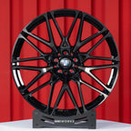 BMW X6 G06 22 inch custom forged wheels | OEM BMW 818M style Gloss Black with Machined Face Dark Coating, straight front view on display stand showcasing iconic dual-tone M wheel design