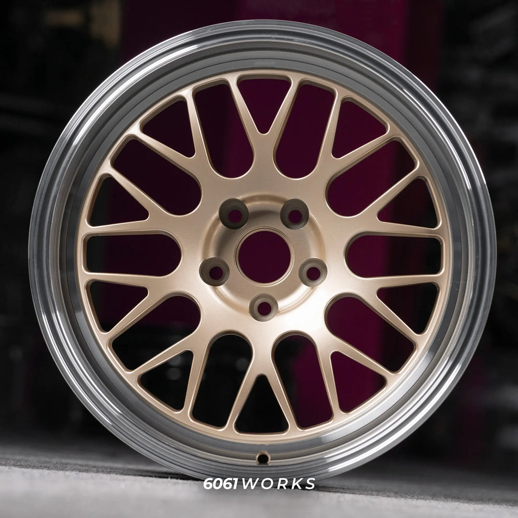 BMW Z4 M E86 Coupe 18 inch custom forged wheels | Apex ML-10RT style Satin Gold with Polished Lip, straight front view on stand