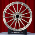 Ferrari 812 Superfast 21 22 inch custom forged wheels | P103SC style Brushed with Gold coating finish, straight front view on red backdrop showing intricate multi-spoke arrangement