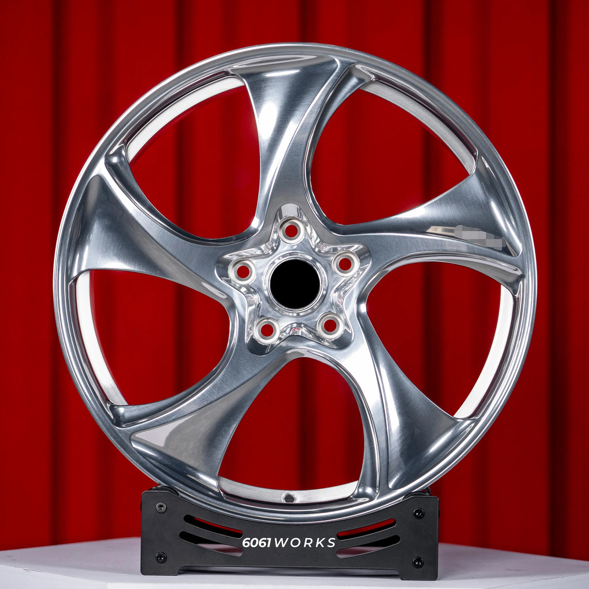Porsche Panamera 4 972 21 inch custom forged wheels | 522M style Polished finish, straight front view on red backdrop displaying directional 5-spoke design