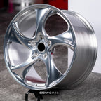Porsche Panamera 4 972 21 inch custom forged wheels | 522M style Polished finish, three-quarter view on display stand showing swept directional spoke geometry