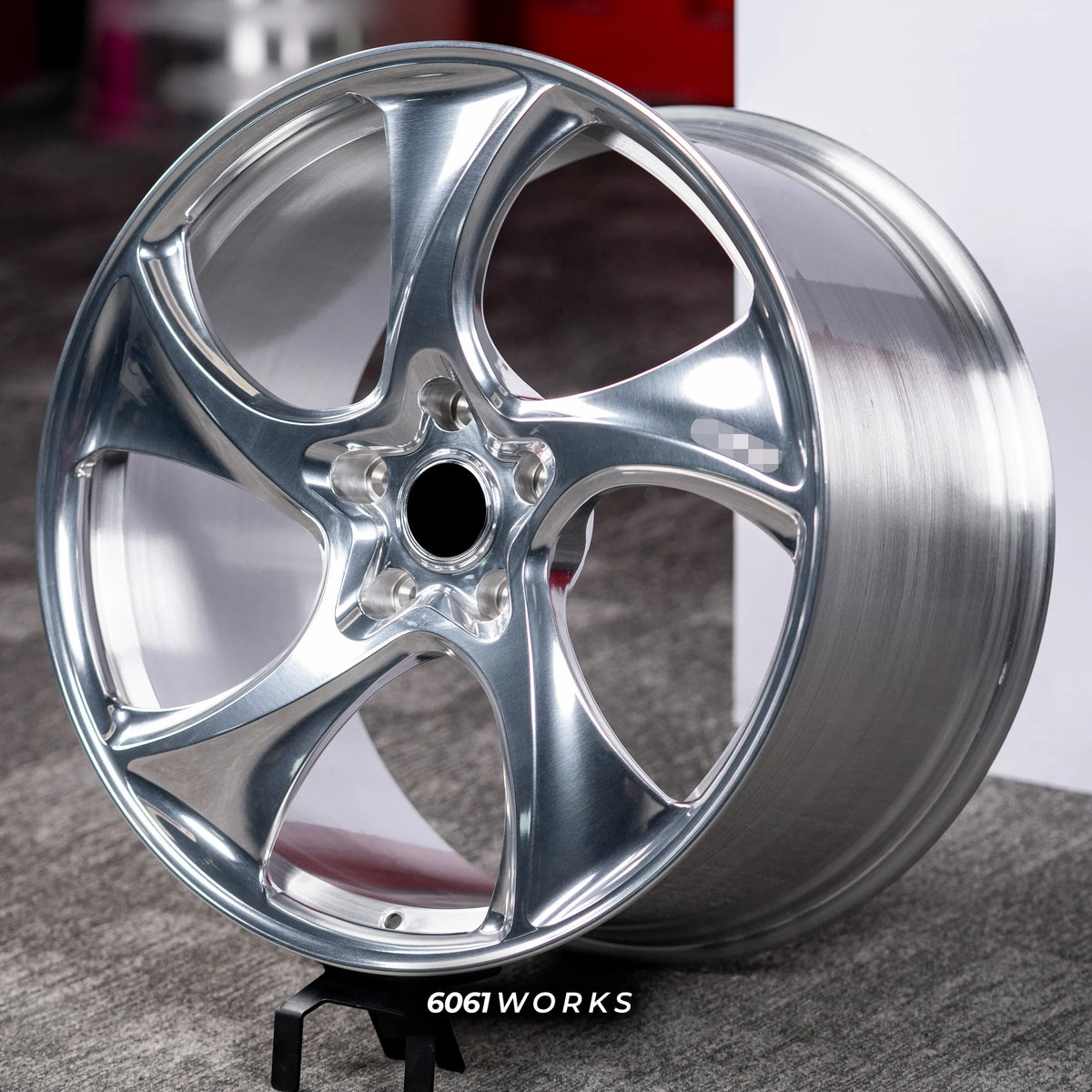 Porsche Panamera 4 972 21 inch custom forged wheels | 522M style Polished finish, three-quarter view on display stand showing swept directional spoke geometry